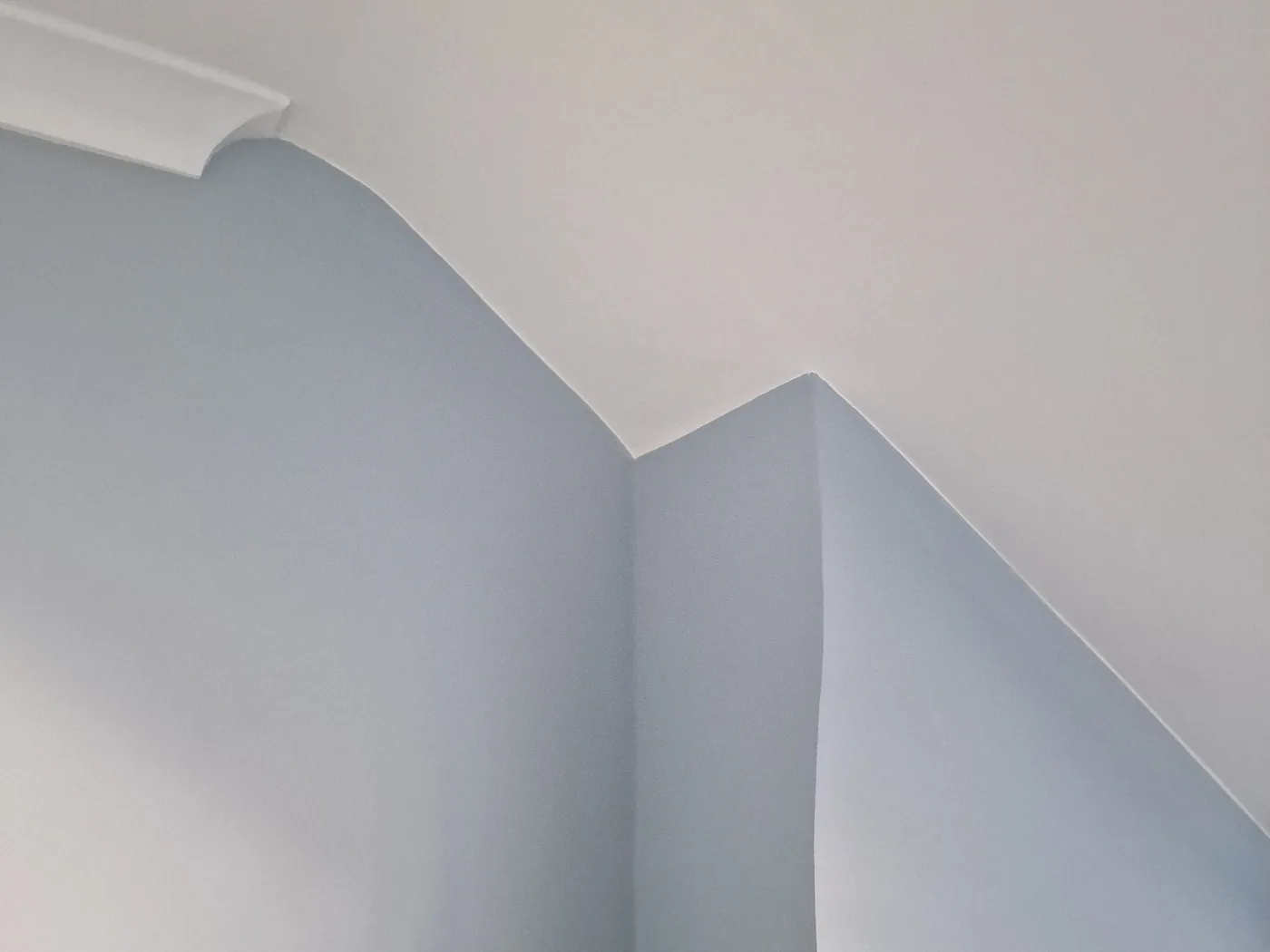 Crisp ceiling line and coving where a sloping ceiling meets the wall