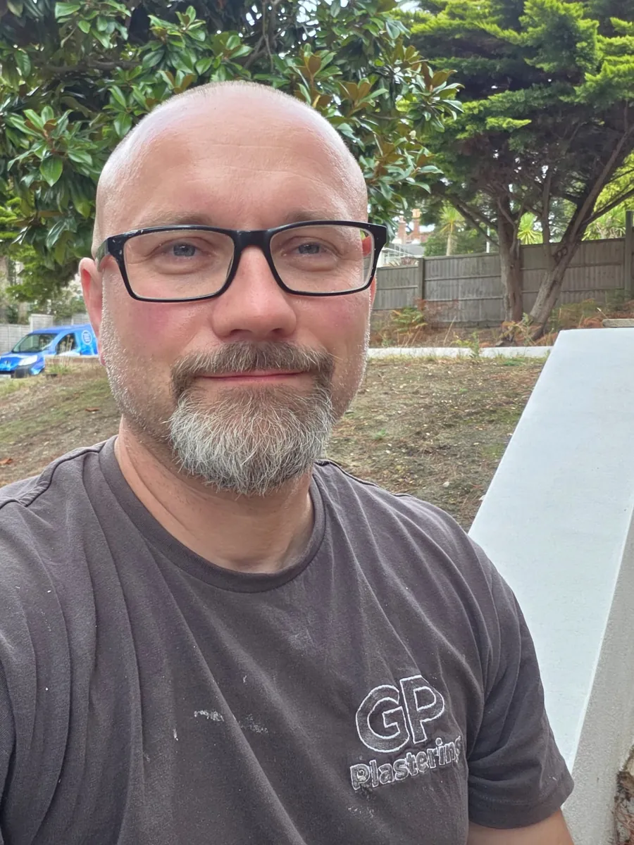 Greg, the owner of GP Plastering, on site in a company work shirt