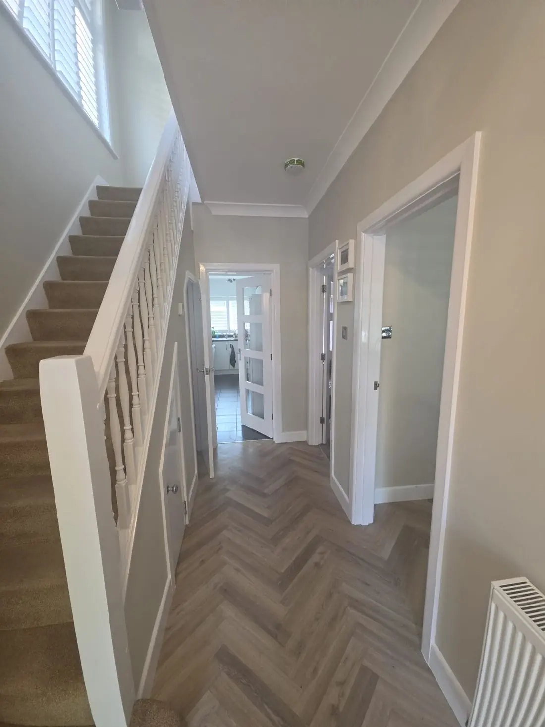 Hallway finished by GP Plastering with fresh plaster, decoration and herringbone flooring