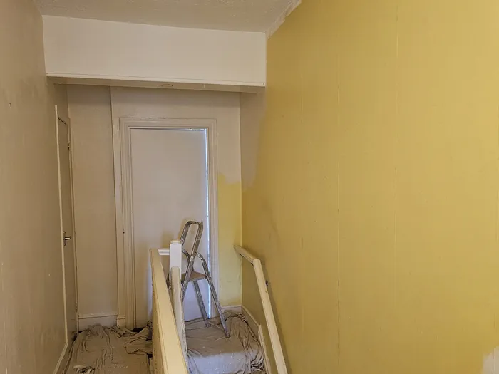 Landing part way through, the old yellow wall being covered