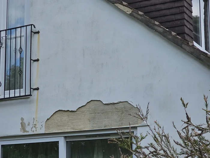 Blown render on a gable wall above a window, Bournemouth