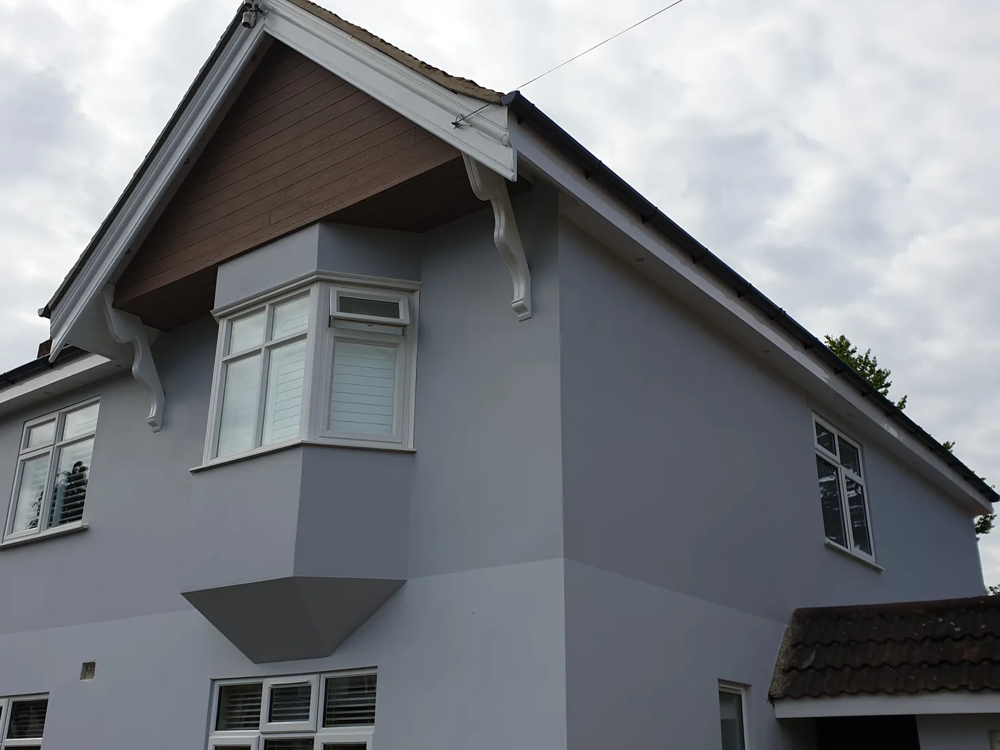 Detached house in Bournemouth rendered and painted grey, white fascias and bay window