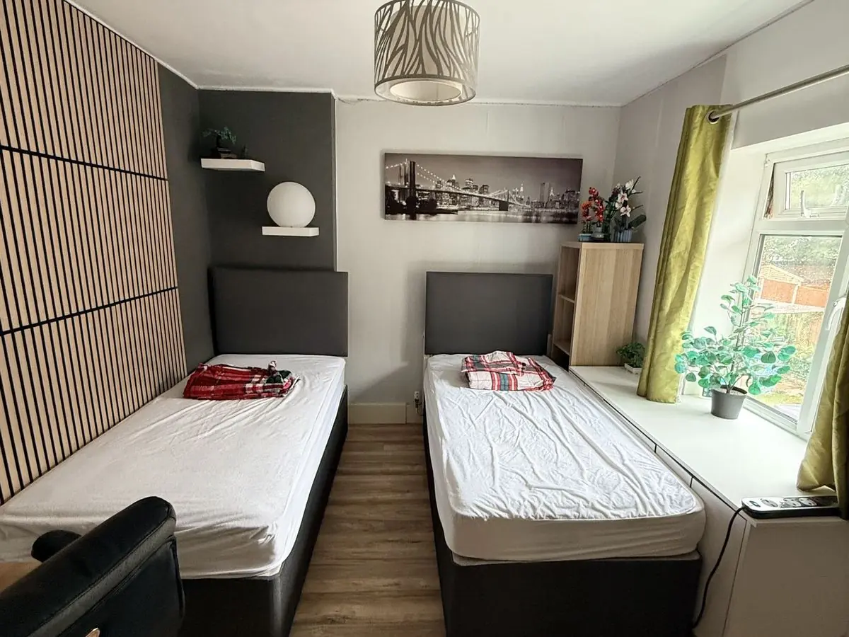 Bedroom finished with painted walls, slatted feature wall and new floor