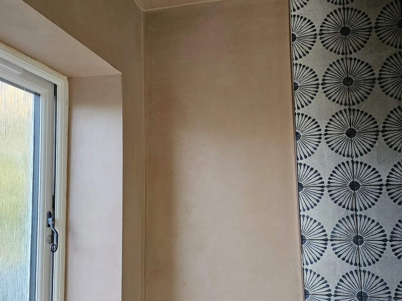 Freshly skimmed wall and sloping ceiling, tight corner against the tiling