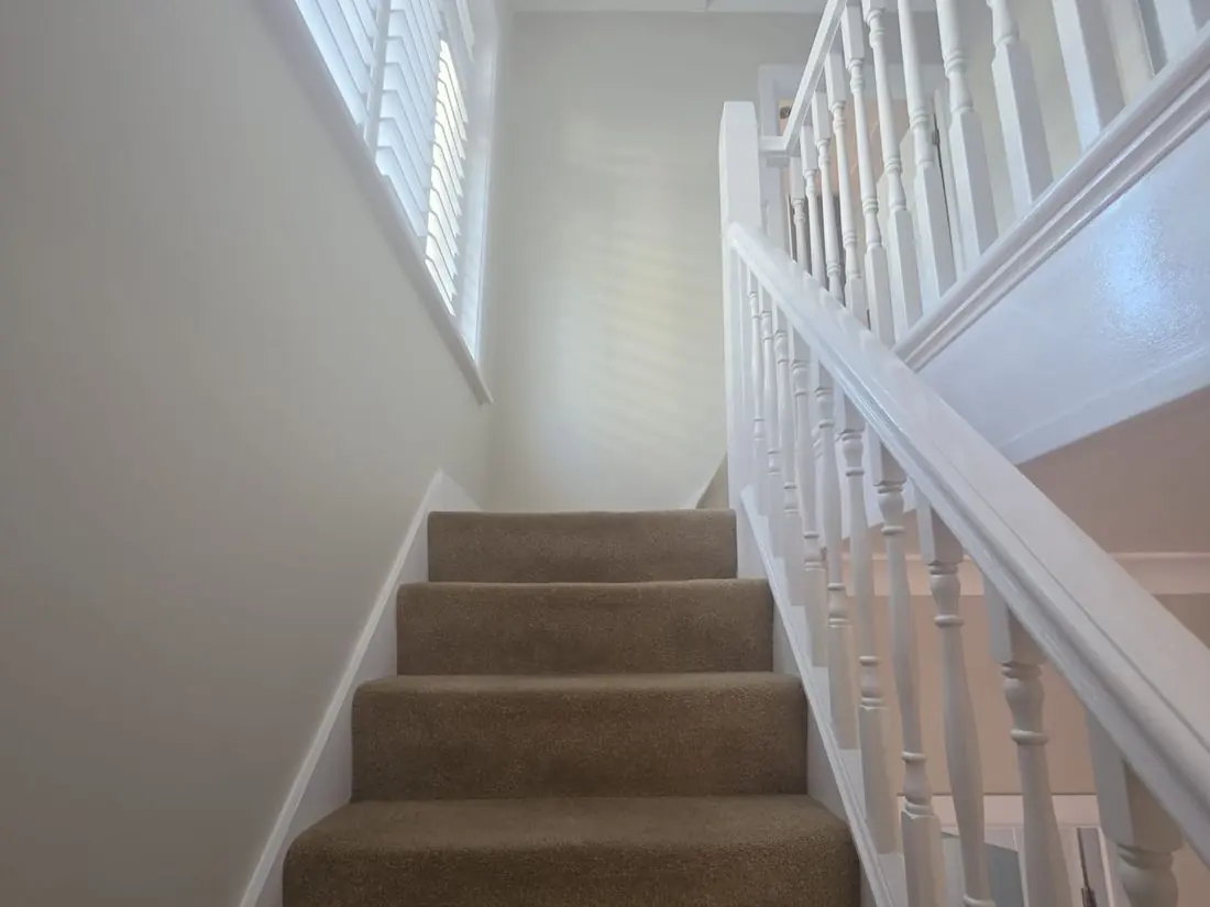 Staircase and stairwell freshly decorated with white woodwork